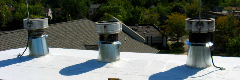 Reader Roofing working on a vents on a commercial roof.