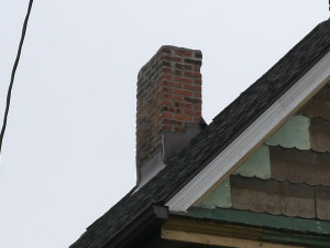 This chimney was tuck-pointed by the home roof repair team at Reader Roofing.