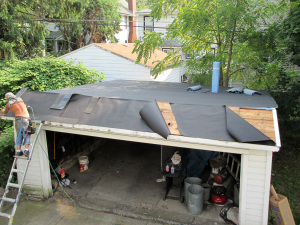 Reader Roofing working on new garage roof installation.
