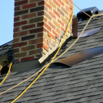 The chimney is in the process of flashing as the roofing contractors install the new roof.