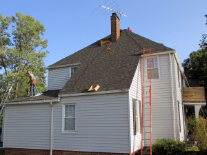 The roofing contractors at Reader finish up the work on this Euclid home.