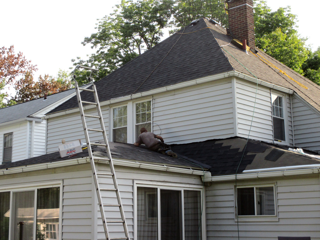 Reader Roofing contractors working on the back of the home.
